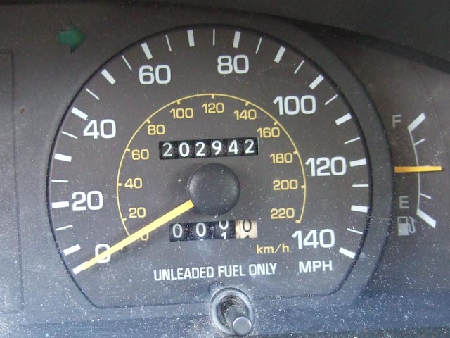 Car odometer showing 202,942 miles on it